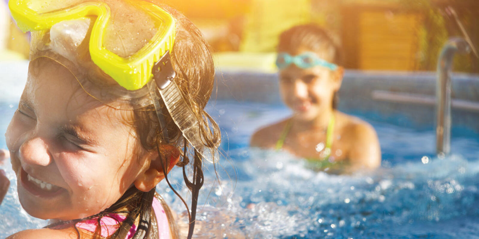 Children playing and splashing in pool