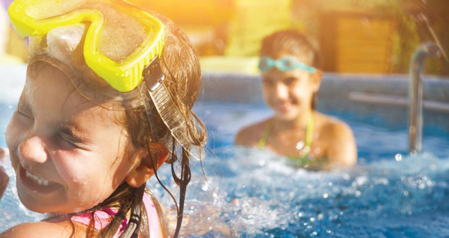 Children playing and splashing in pool